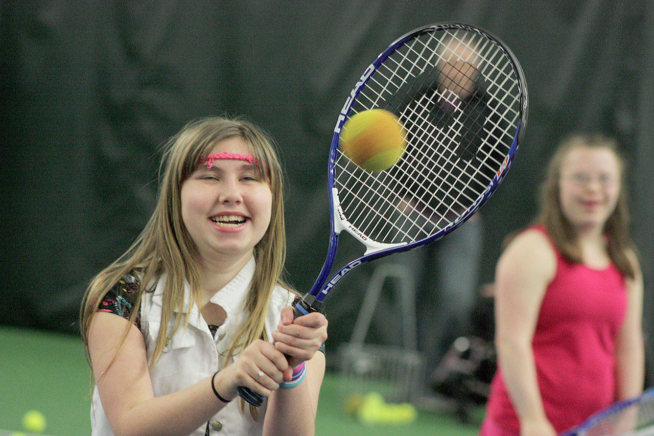 Arianna Conley, 14, breaks into a smile during net play at camp at the Boeing Employees Tennis Center last Saturday. MARK KLAAS, Kent Reporter