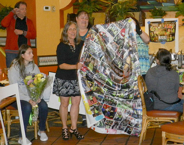 Cathy Brasher-Hwang, who retired this year as coach of the Kent Storm Special Olympics Team, receives a photo blanket in honor of her 10 years coaching the team. COURTESY PHOTO, Jaleesa La Croix