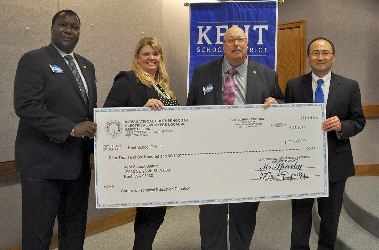 IBEW Local 46 recently presented the Kent School District with a $4,600 donation for its Career and Technical Education program. From left are Sean Bagsby, president of IBEW Local 46; Lorianne Paxton, Kent School District’s director of Career and Technical Education; Jim Tosh, IBEW Local 46’s business manager and financial secretary; and Eric Hong, school improvement officer for the Kent School District. HEIDI SANDERS, Kent Reporter