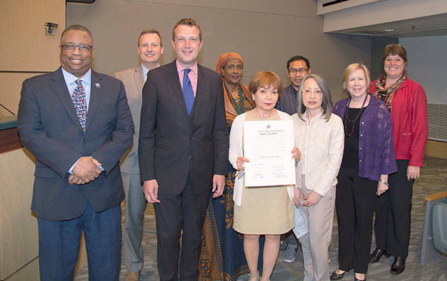 Representatives from several immigration groups join a County Council members Larry Gossett, far left, Dave Upthegrove, second from left, and Joe McDermott, third from left, after the council proclaimed June as Immigrant Heritage Month in King County.