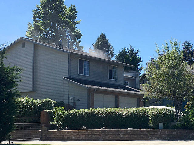 A puff of smoke shoots from a home Thursday in the 13000 block of Southeast 279th Place. Courtesy Photo/Puget Sound Fire