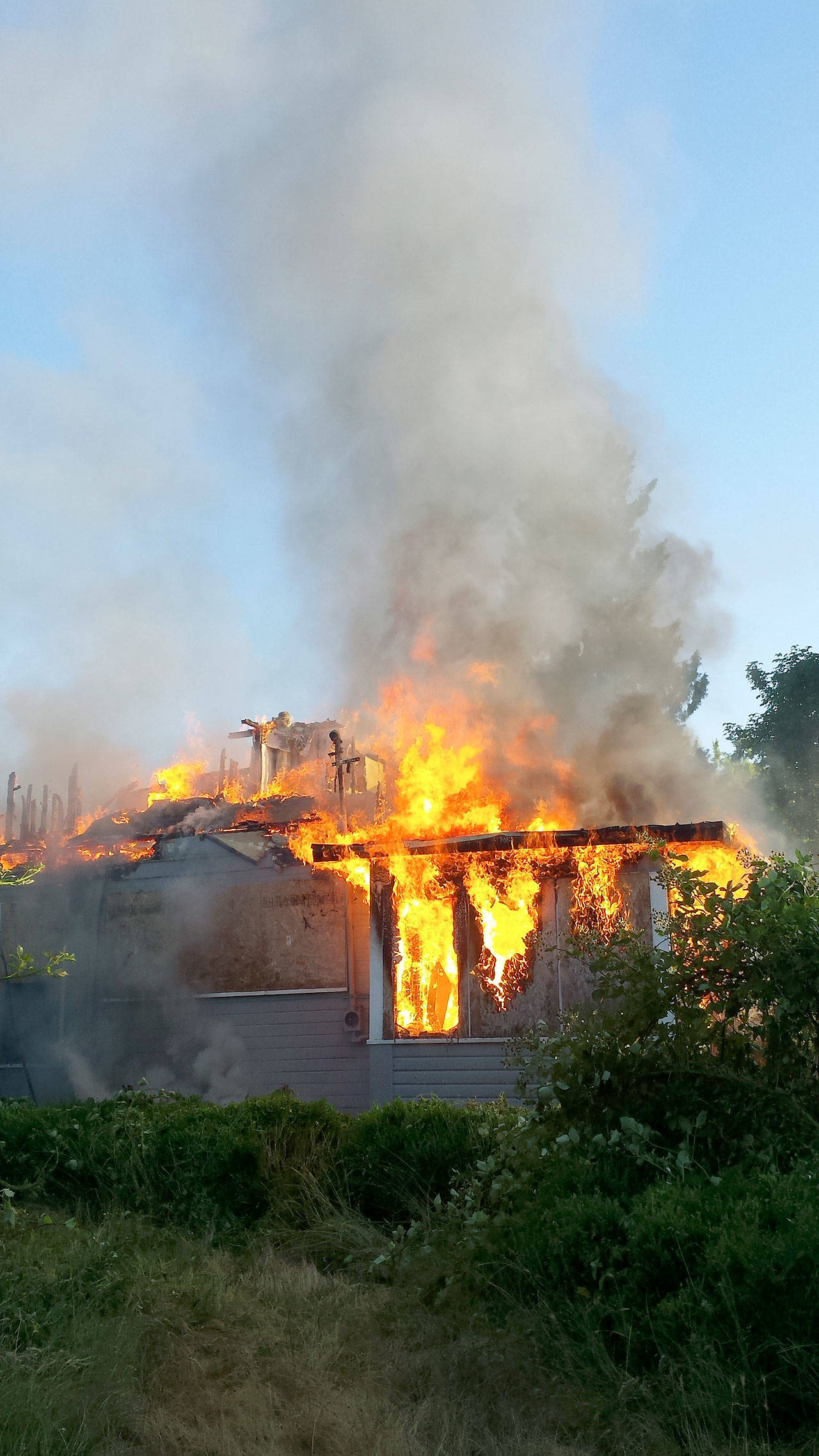 An abandoned house burns on Friday moring in Kent in the 22300 block of Russell Road near the Green River. Courtesy Photo/Puget Sound Fire