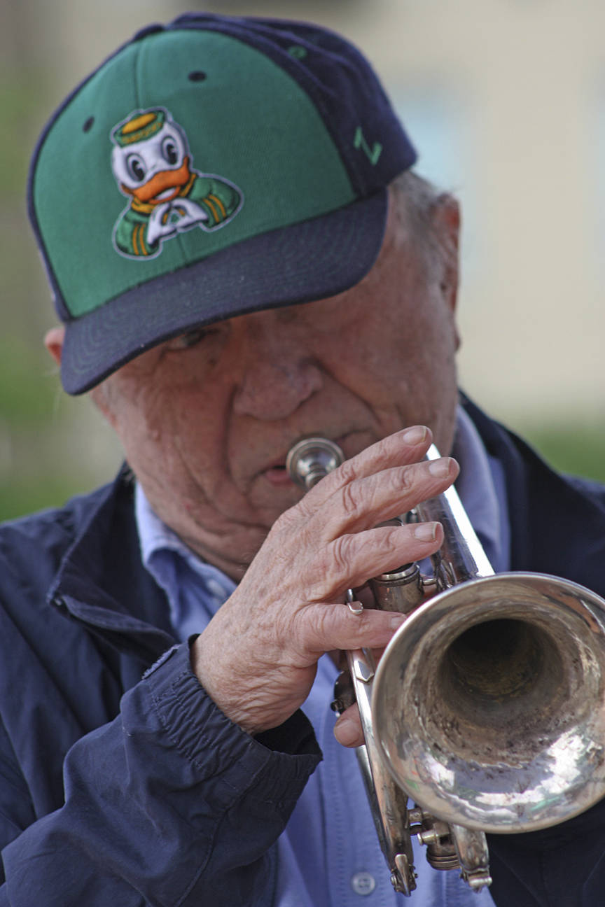 Bert Barr blows his trumpet as he entertains passers-by during the opening of the Kent Farmers Market at the Town Square Plaza on Saturday. Bert plays trumpet and percussion and his wife, Rose Marie, plays piano. Together, the Double Barrs perform jazz and swing music from yesteryear. MARK KLAAS, Kent Reporter