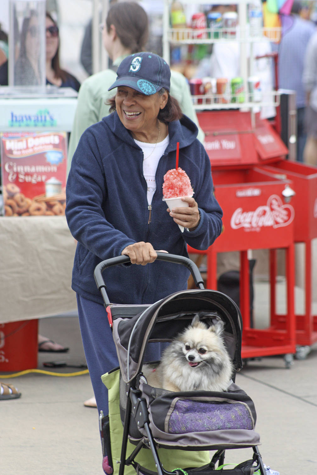 Madeline Hope and her dog, Early, stroll along Second Avenue North in the Town Square Plaza during the opening of the Kent Farmers Market on Saturday. MARK KLAAS, Kent Reporter
