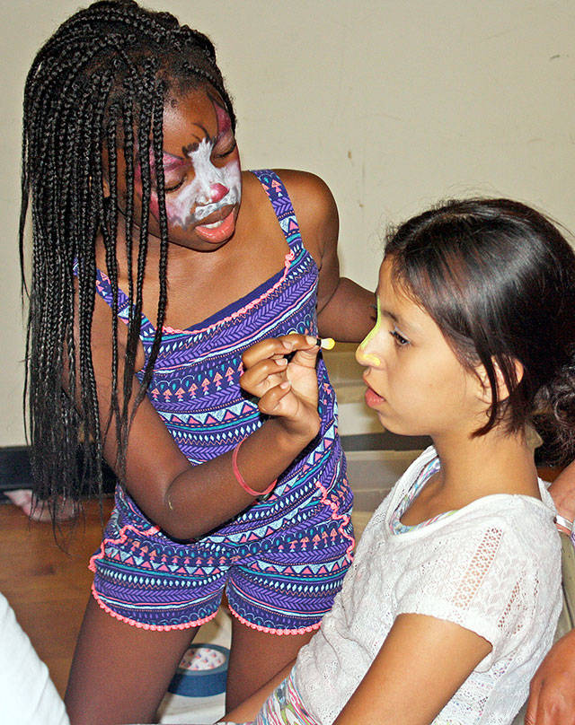 Girls face paint each other at a National Night Out event in 2016 at the Kent Phoenix Academy.