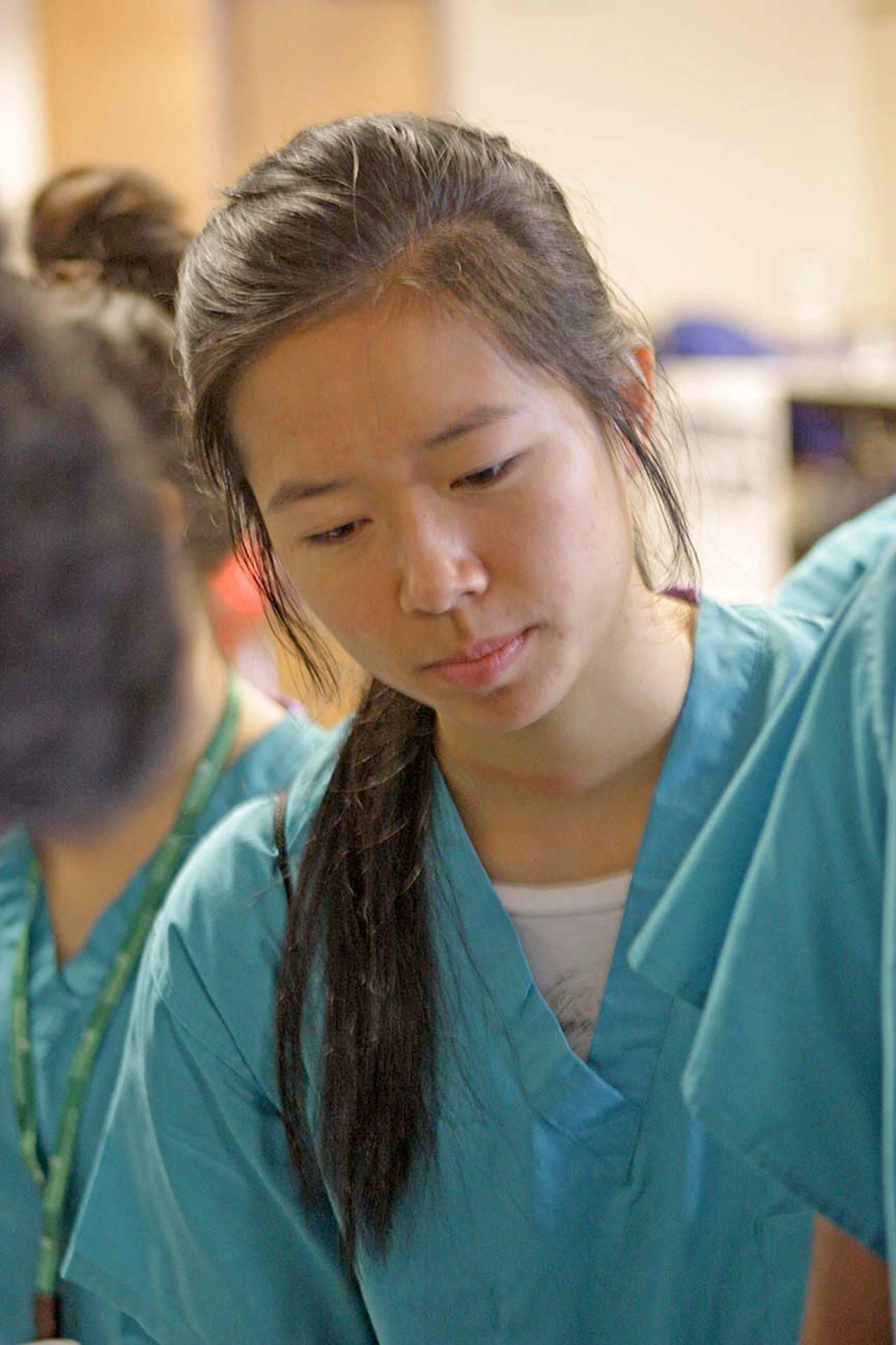 Emily Huynh, who will be a junior at Kentridge High School in the fall, observes a CPR/first aid demonstration during Multicare Nurse Camp last Friday. Huynh said she is considering becoming a surgeon. MARK KLAAS, Kent Reporter
