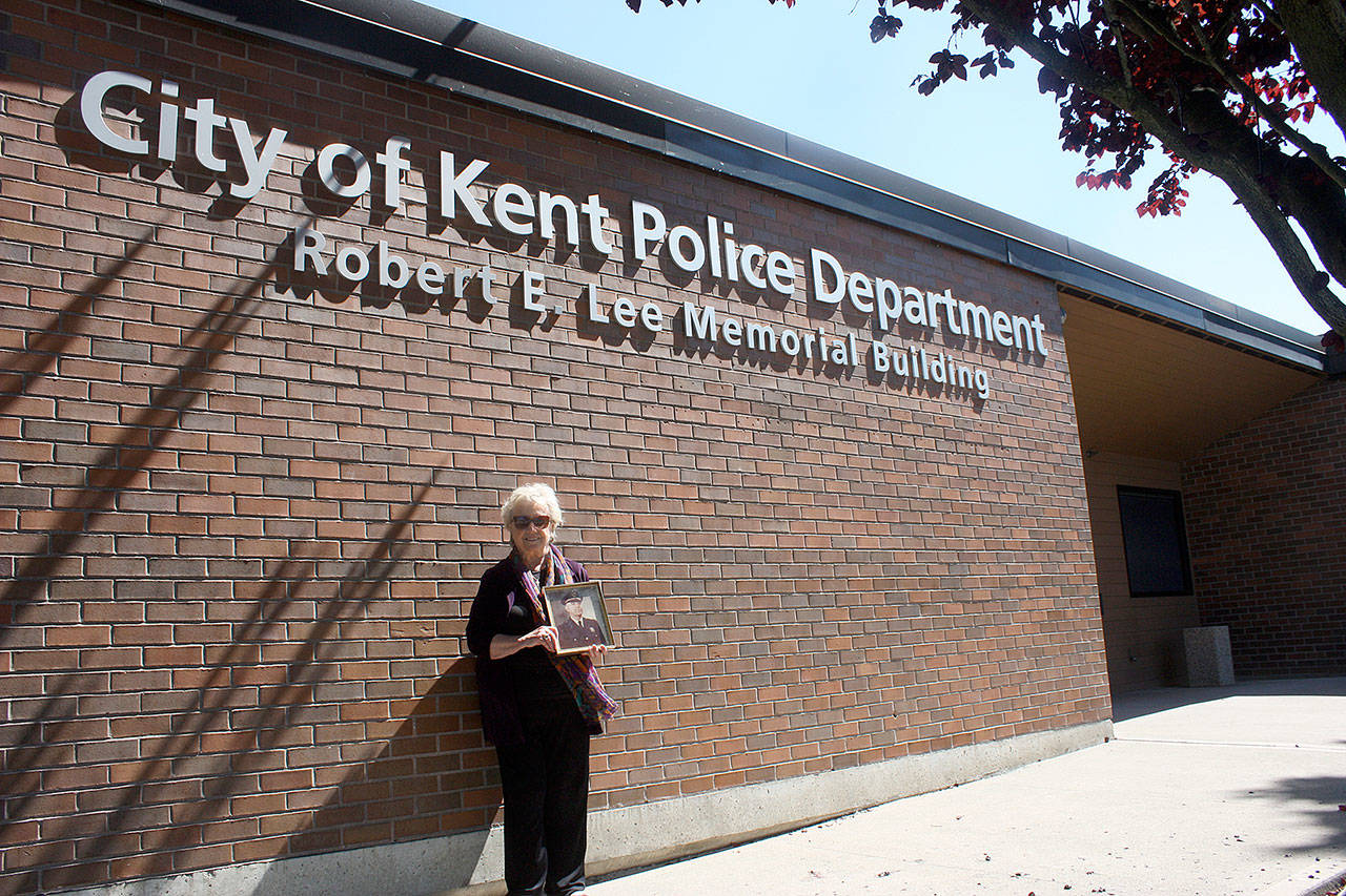 Vicki (Lee) Schmitz stands next to the city of Kent building named after her father Robert E. Lee, a former Kent Police chief. PHOTO/Steve Hunter/Kent Reporter