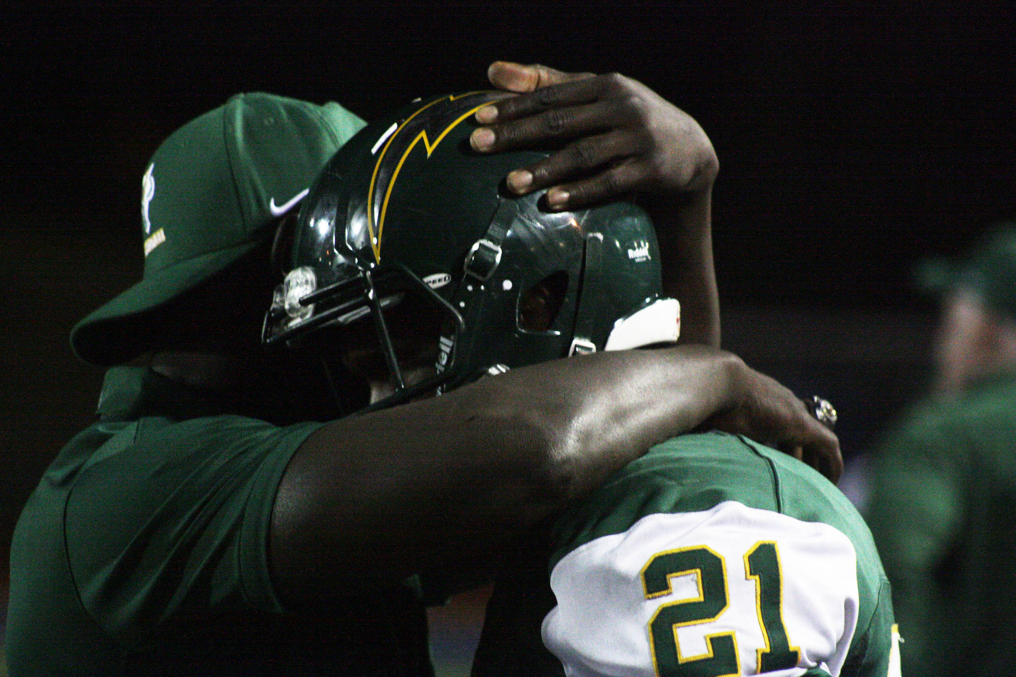 Kentridge assistant coach Victor Tolbert consoles Jeremy Banks during the Chargers’ 38-20 NPSL loss to Kentlake on Friday night. MARK KLAAS, Kent Reporter