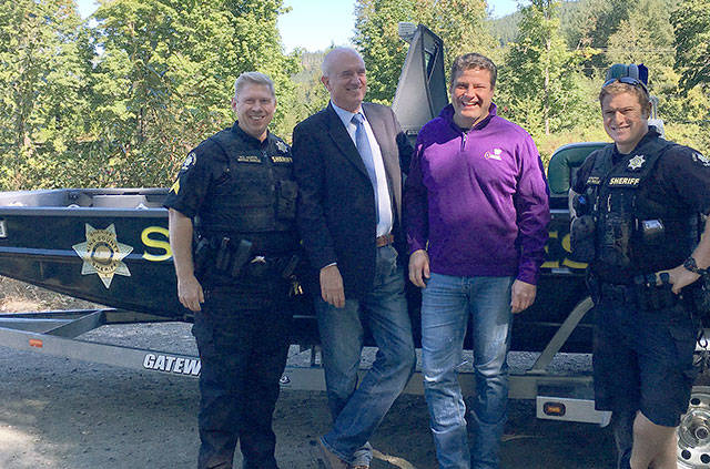 Sgt. Mark Rorvik, KCSO’s Marine Rescue Dive Unit, Sheriff John Urquhart, Flood District Chair Reagan Dunn and deputy Ben Callahan in front of the Sheriff’s Office new river rescue boat. Courtesy Photo/Sheriff’s Office