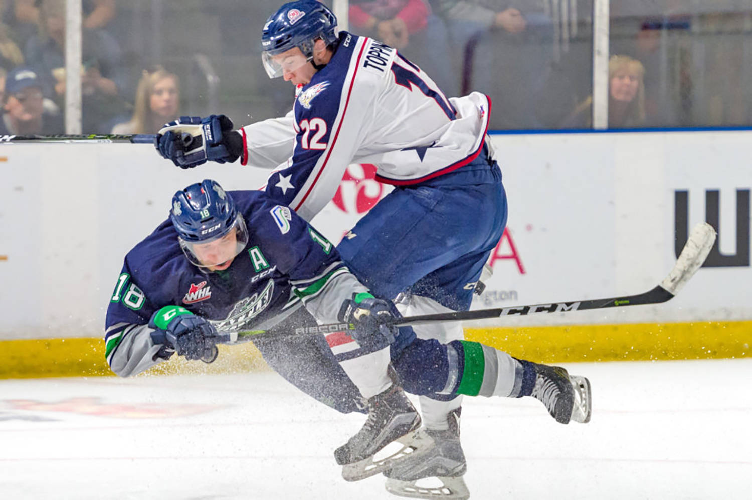 The Thunderbirds’ Sami Moilanen, left, and the Americans’ Jordan Topping collide on the ice during season-opening WHL play Saturday night. COURTESY PHOTO, Brian Liesse, T-Birds