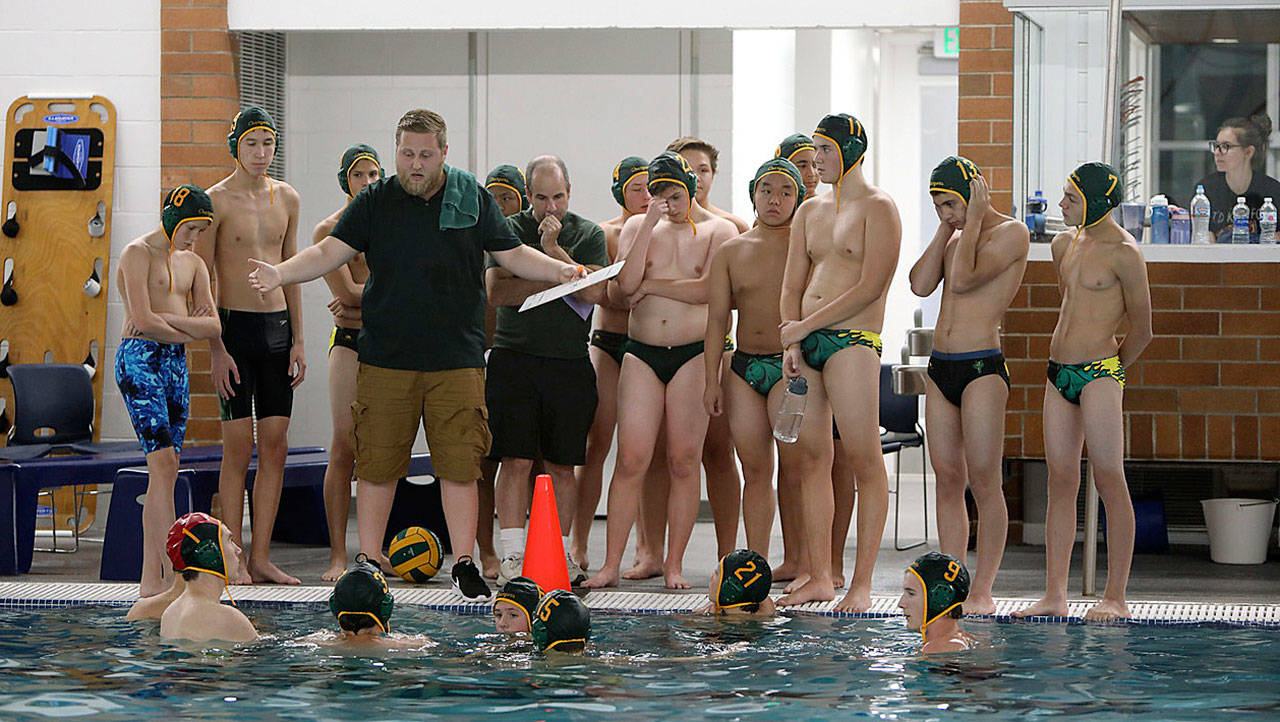 Hunter Arnold gives instruction to his Kentridge team during a recent water polo match. Arnold, fresh out of the waters as a high school and college player, accepted the challenge to coach the young Chargers this fall. COURTESY PHOTO, Tracy Arnold