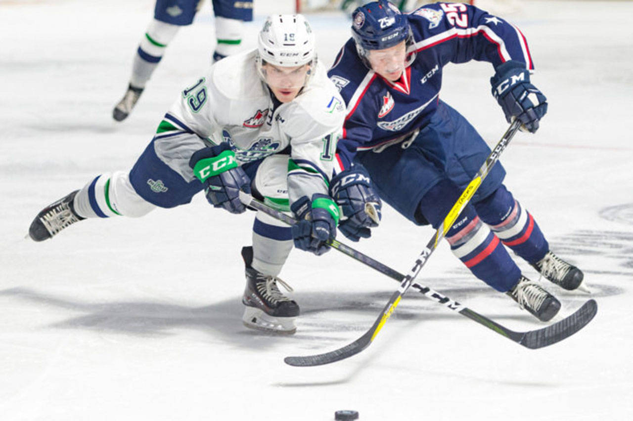 The Americans’ Kyle Olson, right, battles the Thunderbirds’ Donovan Neuls for the puck. COURTESY PHOTO, Brian Liesse, T-Birds