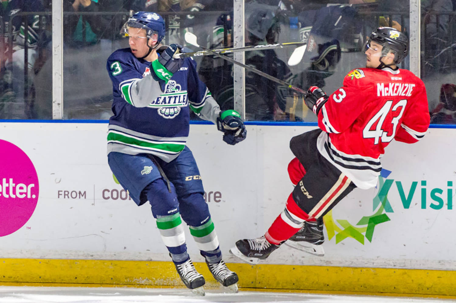 Thunderbirds rookie Cade McNelly, left, and the Winterhawks’ Skyler McKenzie collide along the boards during WHL play Saturday night at the accesso ShoWare Center. COURTESY PHOTO, Brian Liesse, T-Birds