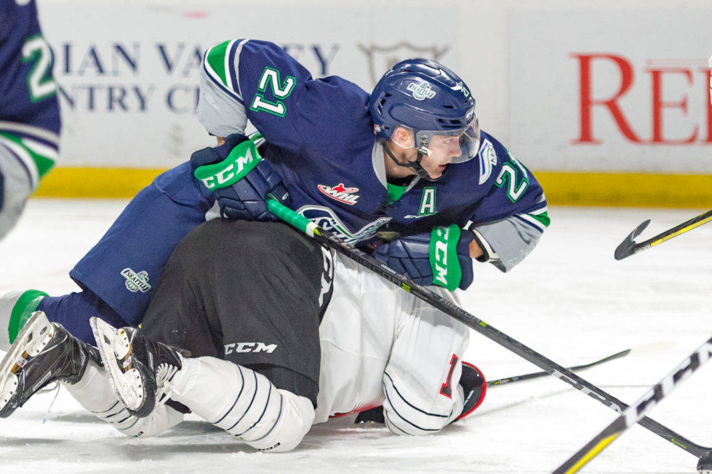 The Thunderbirds’ Matthew Wedman looks for the puck after colliding with a Warrior skater during WHL action Saturday night. COURTESY PHOTO, Brian Liesse, T-Birds