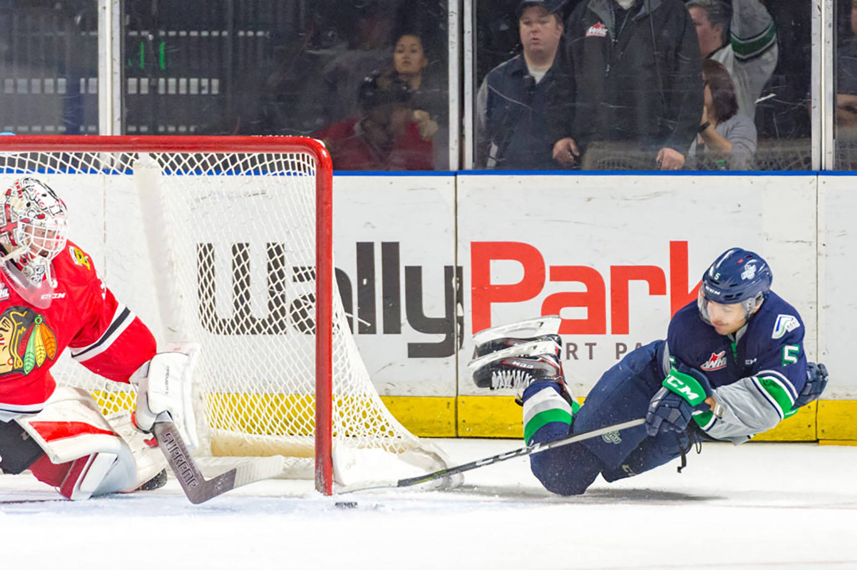 The Thunderbirds’ Jarret Tyszka reaches to fire the puck past Winterhawks goalie Cole Kehler for the game-winning goal in overtime Saturday night at the access ShoWare Center. COURTESY PHOTO, Brian LIesse, T-Birds