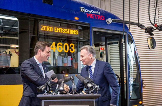 King County Executive Dow Constantine, right, at a press conference about zero emissions Metro buses. Courtesy Photo, King County