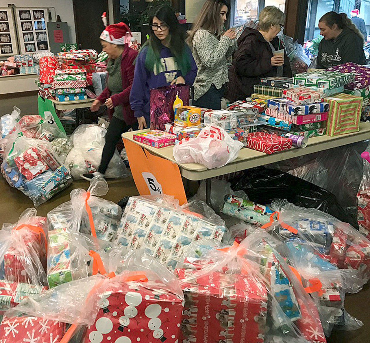 Volunteers organize gifts as part of the annual Toys for Joy program. COURTESY PHOTO, Puget Sound Fire