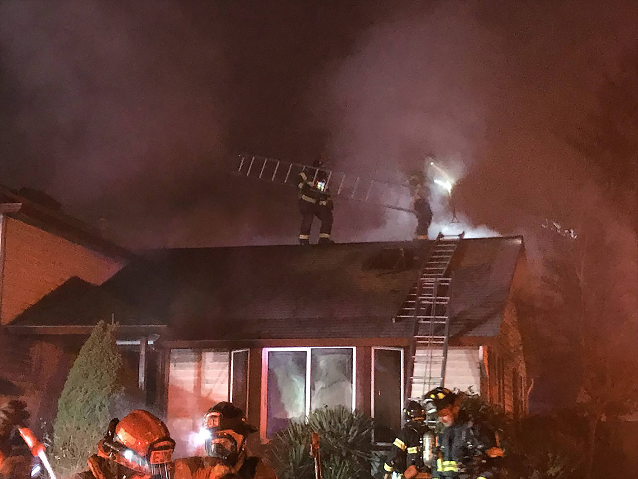 Local firefighters work to extinguish a Kent house fire early Monday morning. COURTESY PHOTO, Puget Sound Regional Fire Authority