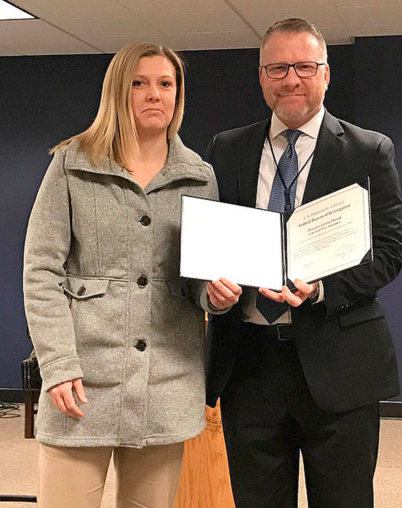 Kent Police Detective Lovisa Dvorak, left, receives an award of appreciation Tuesday from Special Agent in Charge Jay S. Tabb Jr. at the FBI office in Seattle for her contributions to the joint task force on Child Exploitation regarding Human Trafficking. COURTESY PHOTO, Kent Police