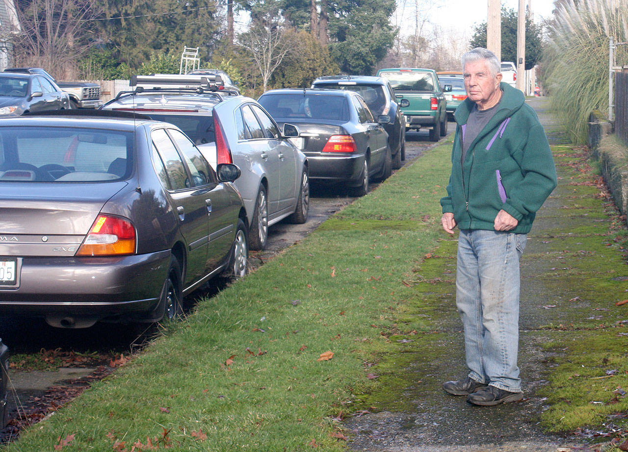 Jim McHugh, a 35-year Mill Creek neighborhood resident, has seen the street in front of his home, attract a heavy volume of parked cars from train commuters who have discovered it’s a good place to leave a busy Sound Transit-Kent Station area. STEVE HUNTER, Kent Reporter