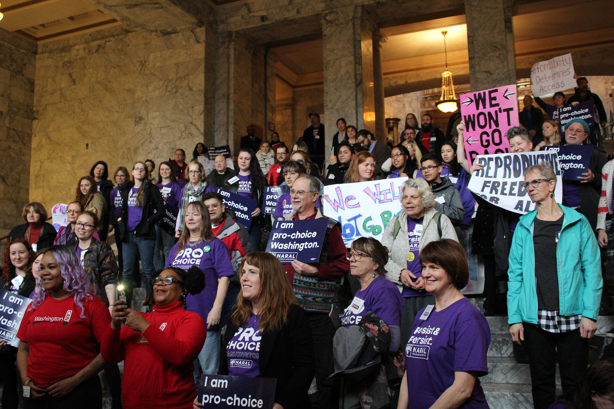 Nearly 100 people gathered in the Capitol Legislative Building in Olympia on Thursday, Jan. 18, to rally in support of the Reproductive Parity Act and other women’s health bills. Photo by Taylor McAvoy