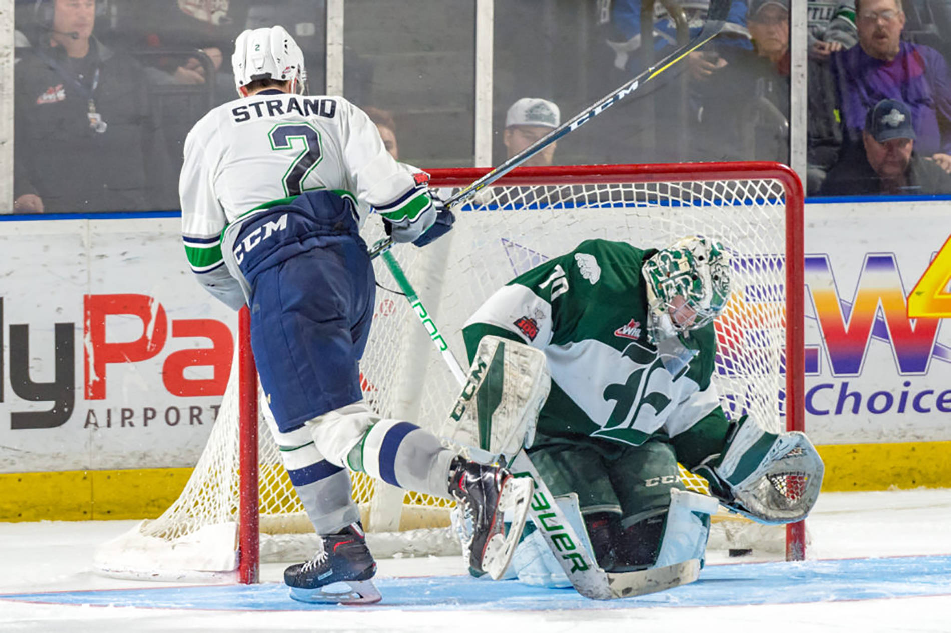 The Thunderbirds Austin Strand slides the puck past Silvertips goalie Carter Hart in what turned out to be the game-winning shot in Saturday nights shootout at the accesso ShoWare Center. COURTESY PHOTO, Brian Liesse, T-Birds