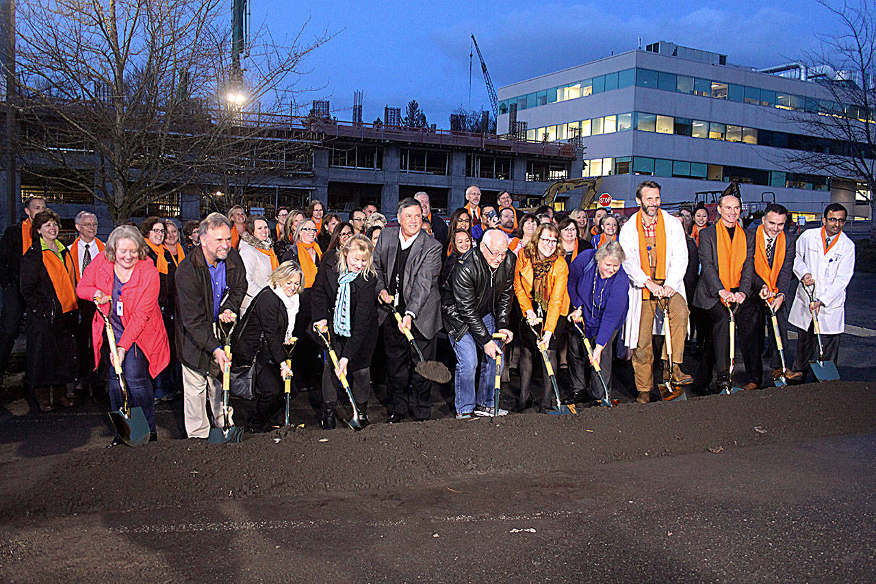 Kent Mayor Dana Ralph, fifth from right, and Renton Mayor Denis Law, fifth from left, join others on Jan. 22 at the groundbreaking of a new facility at Valley Medical Center in Renton that will house a cancer center and orthopedic surgical program. LEAH ABRAHAM, Renton Reporter