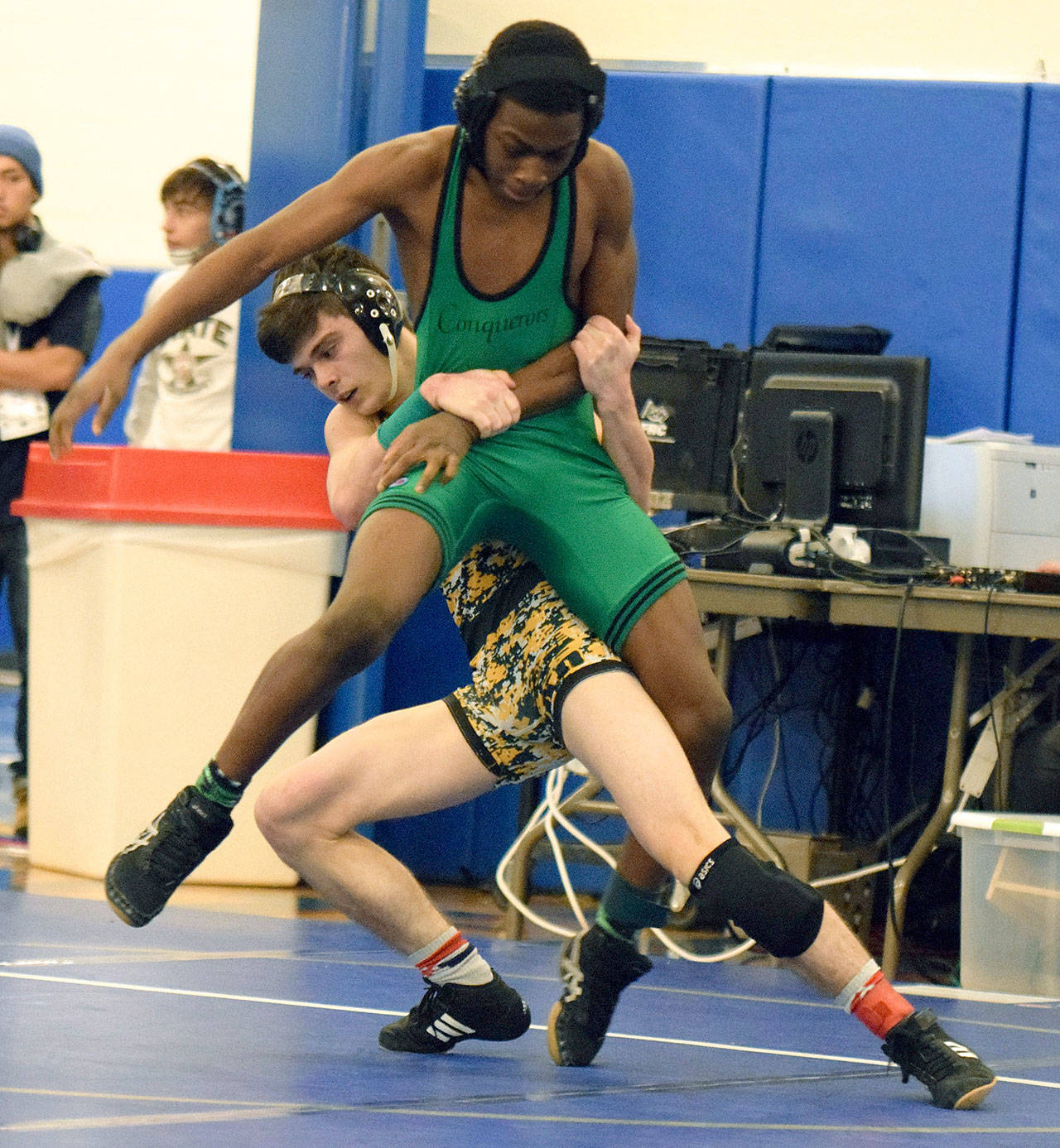 Kentridge’s William Sirbu tries to bring down Kentwood’s Shawn Salomon during their 106-pound title match at the North Puget Sound League Cascade Division League and sub-regional tournament last Saturday. RACHEL CIAMPI, Reporter