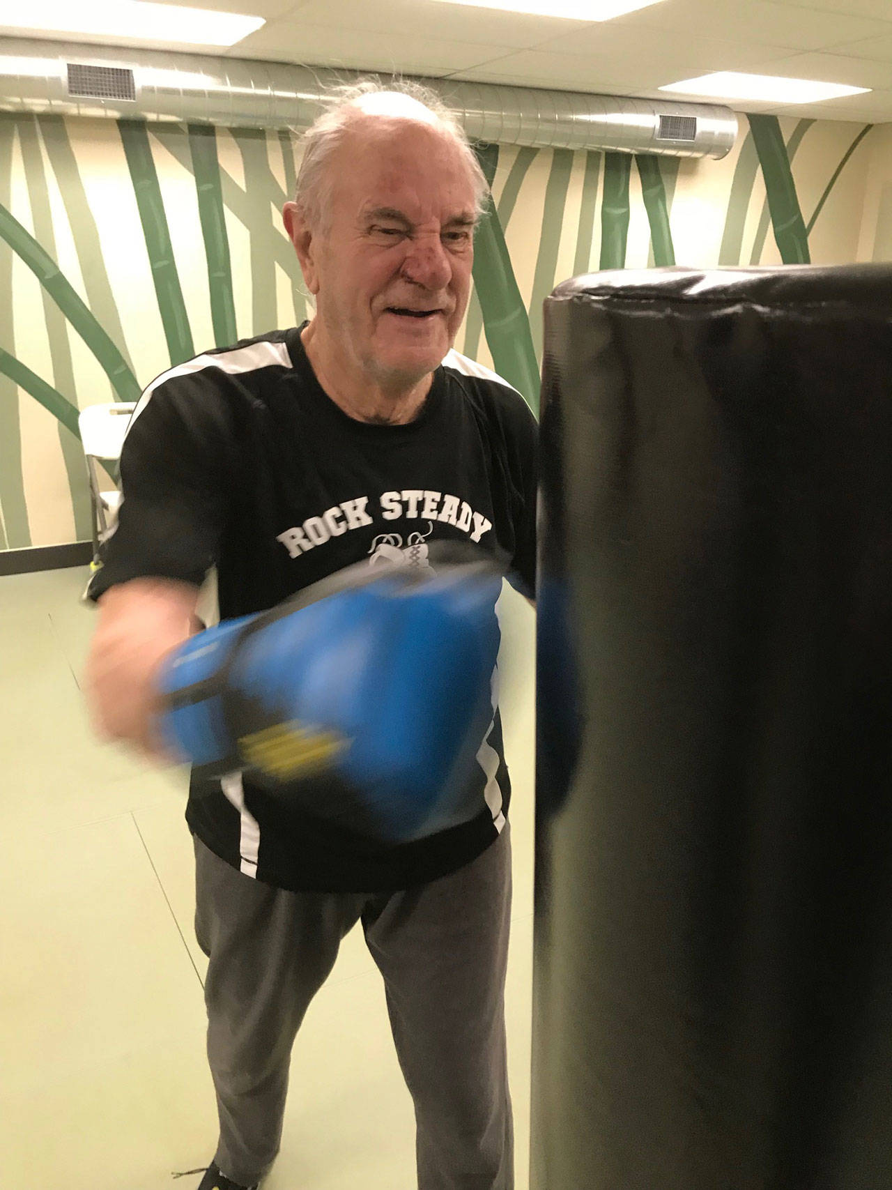 Ted Heikell, 79, of Renton, throws a punch at a bag during a Rock Steady Boxing workout at Longevita Pilates & Yoga Studio in Auburn last week. The therapy session is designed to help those combat symptoms of the disease. MARK KLAAS, Auburn Reporter