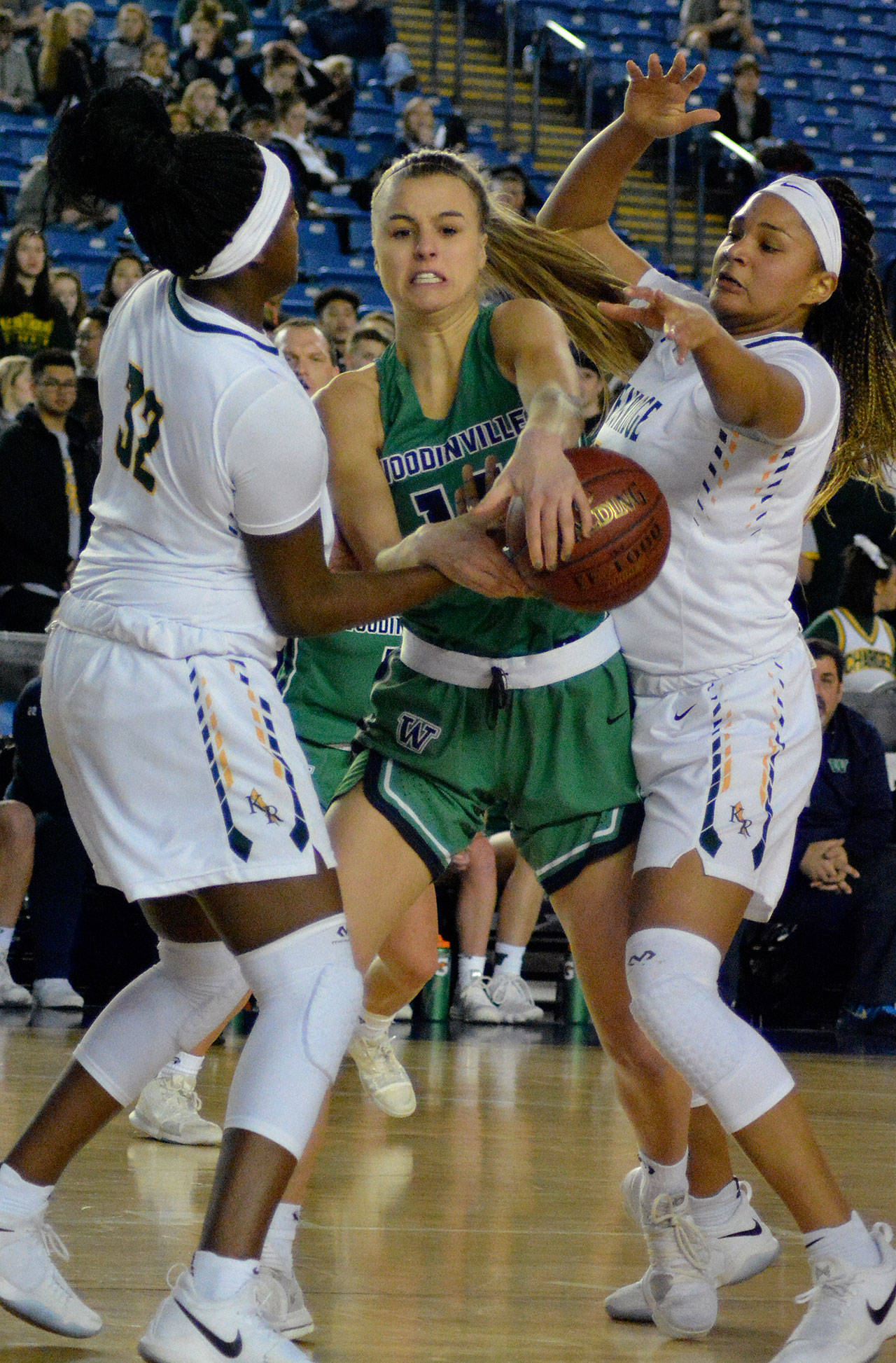Kentridge’s Jordyn Jenkins, left, and Jaquaya Miller try to pry the ball from Woodinville’s Madison Lundquist during state 4A quarterfinal action Thursday. KAYSE ANGEL, Reporter