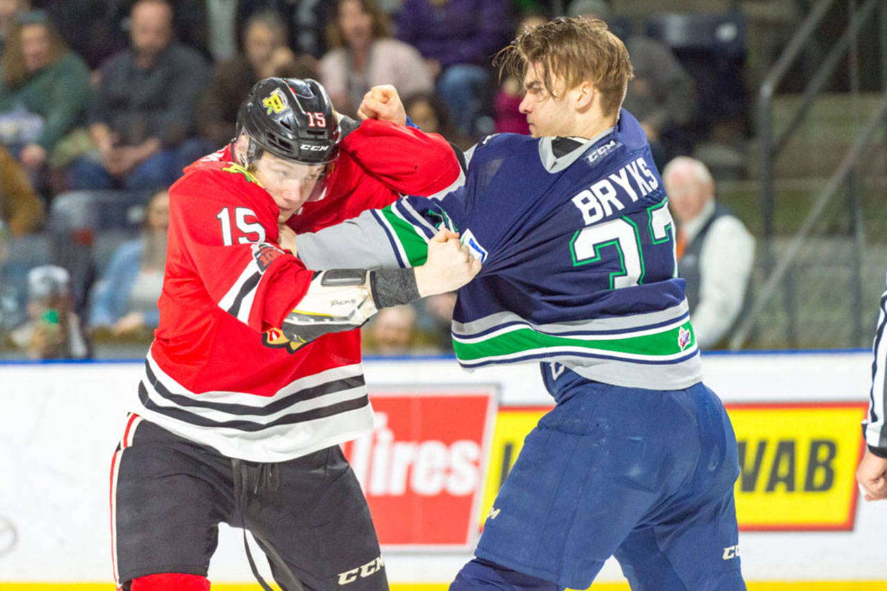 The Thunderbirds’ Graeme Bryks, right, scuffles with the Winterhawks’ John Ludvig during WHL play Sunday. COURTESY PHOTO, Brian Liesse, T-Birds