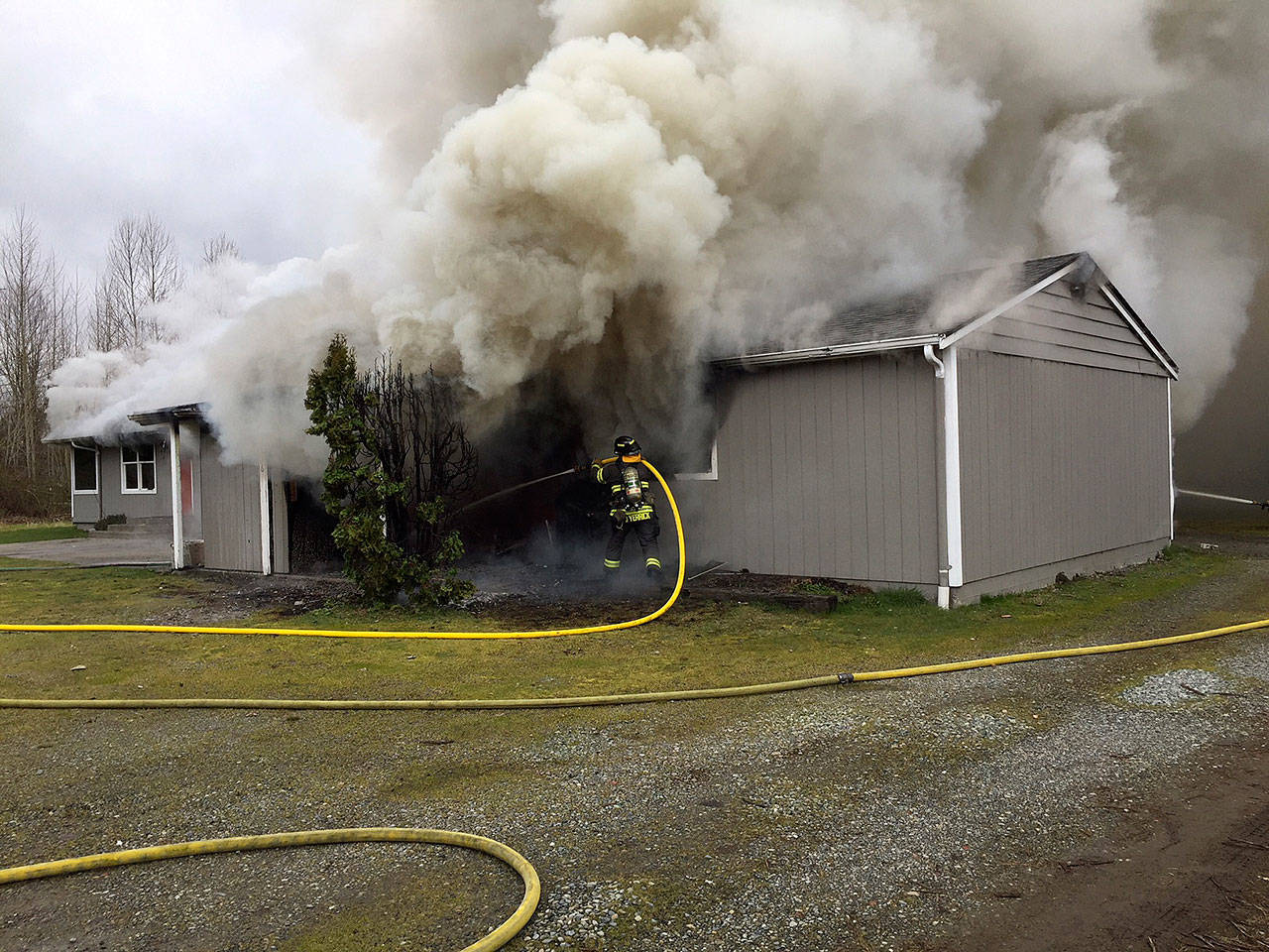 Crews battle a house fire Monday in the 11000 block of Southeast 204th Street. COURTESY PHOTO, Puget Sound Fire