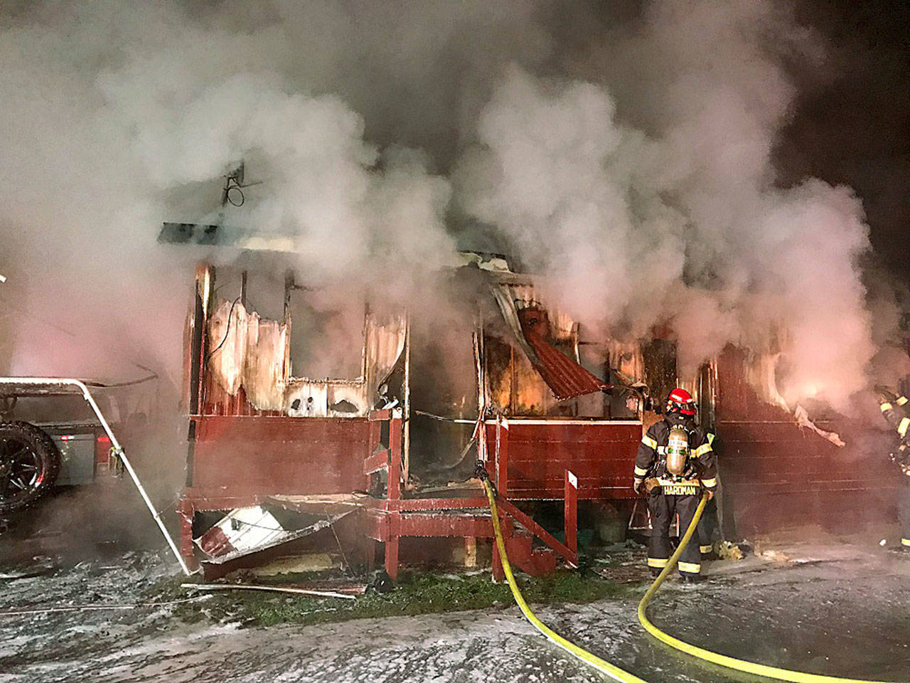Puget Sound Regional Fire Authority firefighters douse a double-wide mobile home fire in the 24400 block of 64 Avenue South early Monday morning. COURTESY PHOTO, Puget Sound RFA