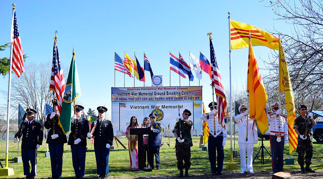 Alyssa Pham, Roselie Nguyen and veteran Ton That Hong address the crowd with honor guards holding flags at the groundbreaking for the Vietnamese-American War Memorial at Les Gove Park on Sunday. RACHEL CIAMPI, Auburn Reporter