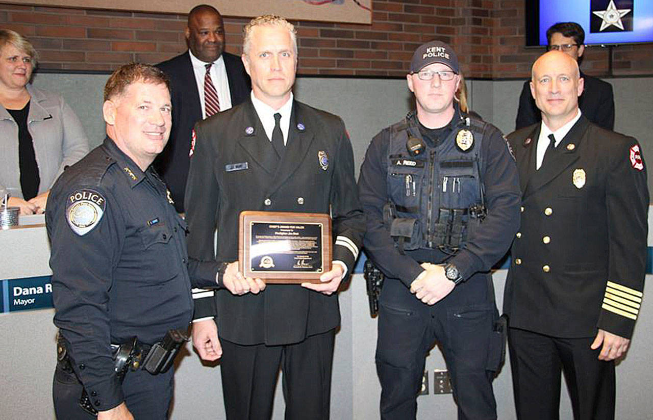 Firefighter Jim Blatt receives the Chief’s Award for Valor from Kent Police Chief Ken Thomas joined by Officer Andrew Reed and Fire Chief Matt Morris. COURTESY PHOTO, Kent Police