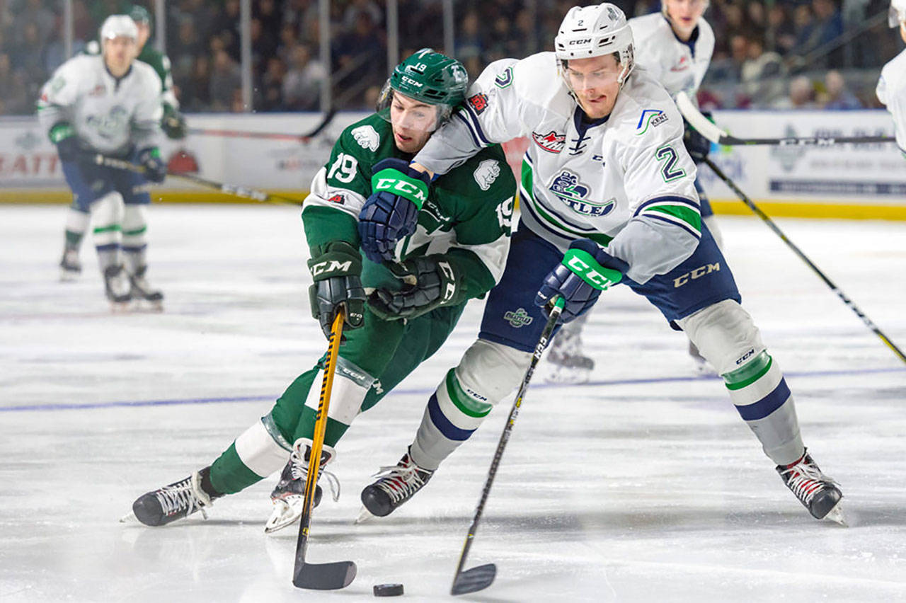 Thunderbirds defenseman Austin Strand, right, battles the Silvertips’ Bryce Kindopp for the puck during Game 3 playoff action Tuesday night. COURTESY PHOTO, Brian Liesse, T-Birds