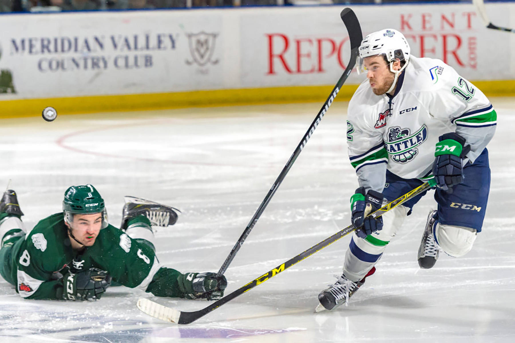 The Thunderbirds’ Blake Bargar goes after a loose puck in front of fallen Silvertip Patrick Bajkov during Game 4 action Friday night. COURTESY PHOTO, Brian Liesse, T-Birds