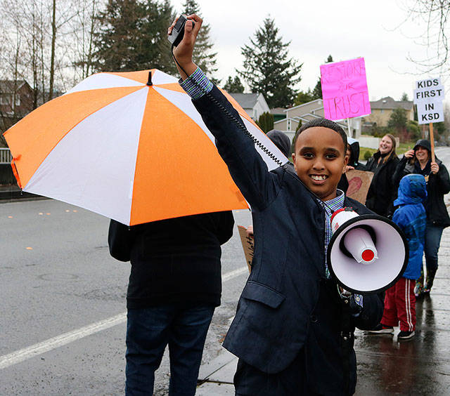 Scenic Hill Elementary fifth grader Ismail Moalim takes charge of the megaphone, leading the crowd with uplifting words on Wednesday outside of Kent School District administrative offices along Southeast 256th Street. He cites his teachers as his inspiration for attending the rally. MEGAN SAUNDERS, For the Kent Reporter