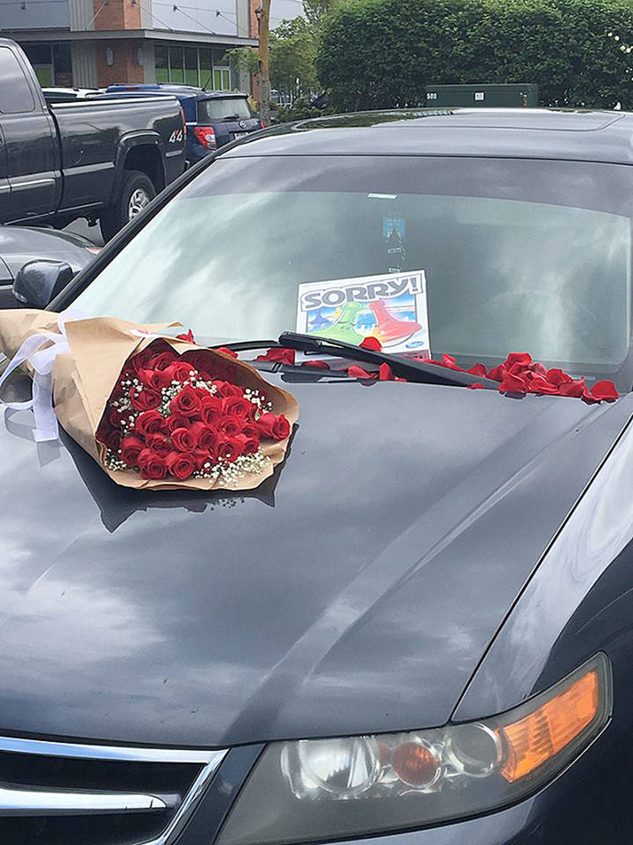 Someone left roses and a message on a car parked Tuesday, May 1 at the Kent Station shopping center parking lot. Kent Station posted the photo on its Facebook page, but the mystery remains. COURTESY PHOTO