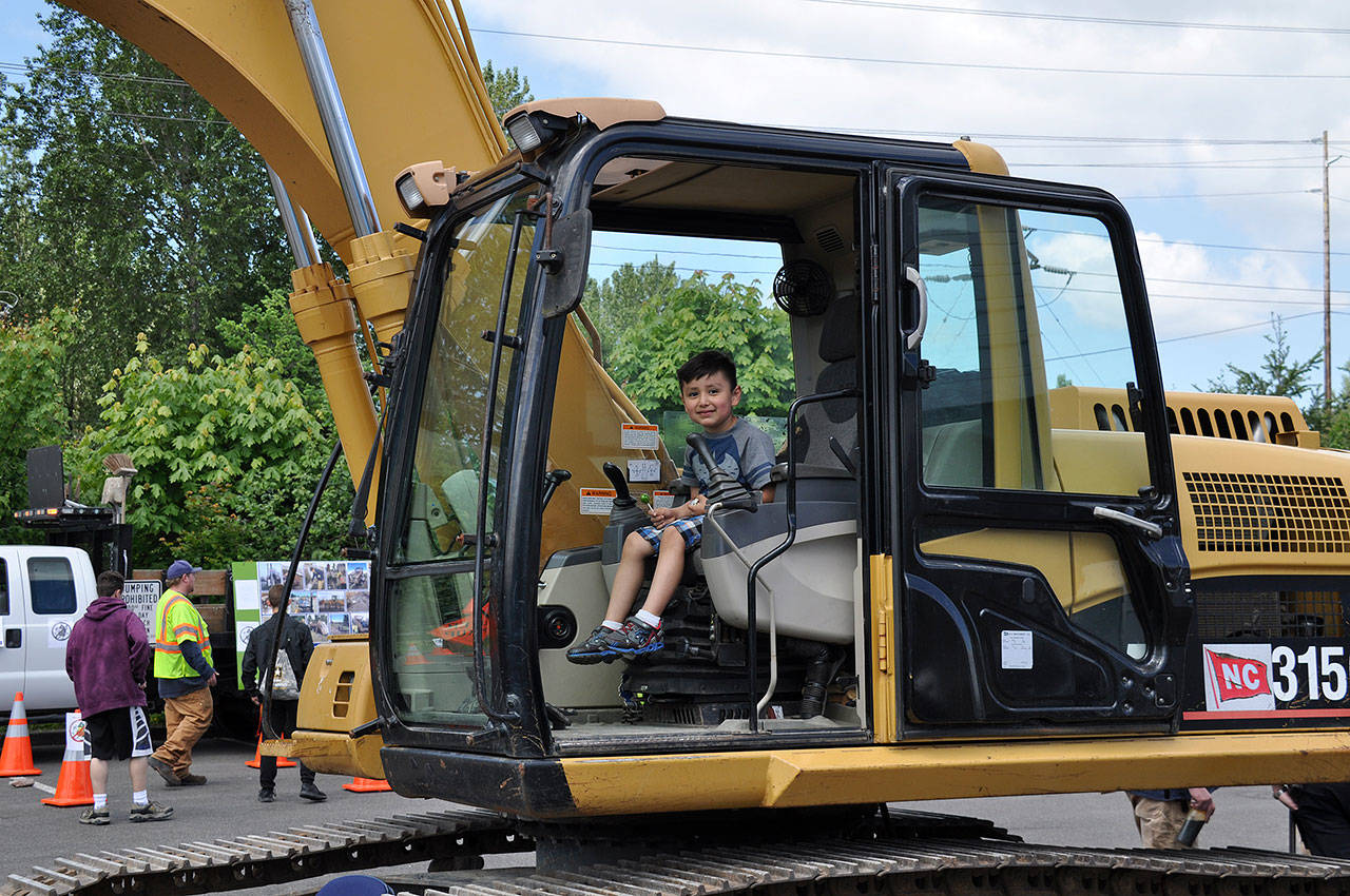 A boy gets a chance to sit in equipment used by city of Kent Public Works crews during the 2017 Public Works Week celebration. This year’s event is May 31 at the accesso ShoWare Center. FILE PHOTO, Kent Reporter