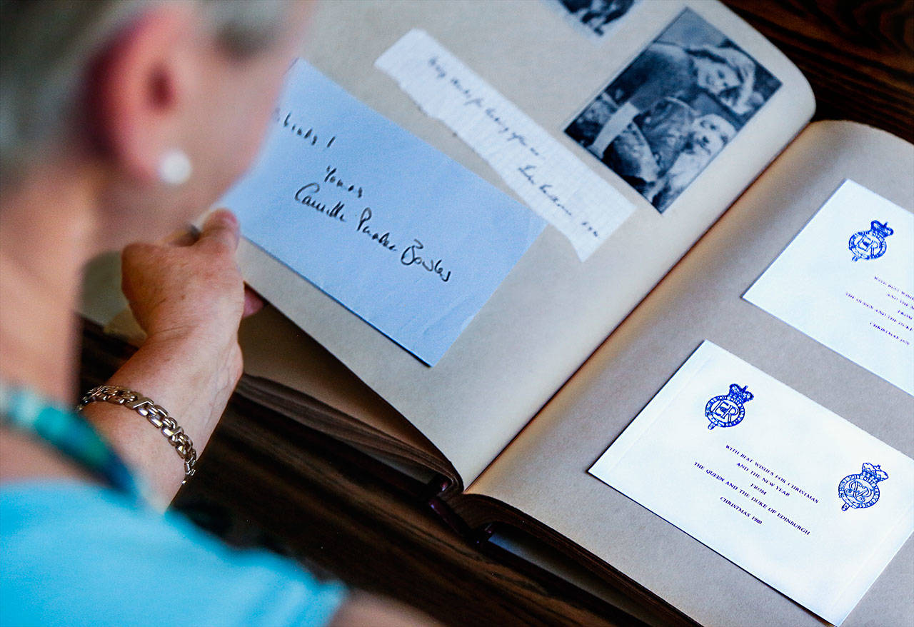 Among Janette Huskie’s scrapbook items is a handwritten note to her from Camilla Parker Bowles, now the wife of Prince Charles, as well as Christmas cards from Queen Elizabeth. (Dan Bates / The Herald)
