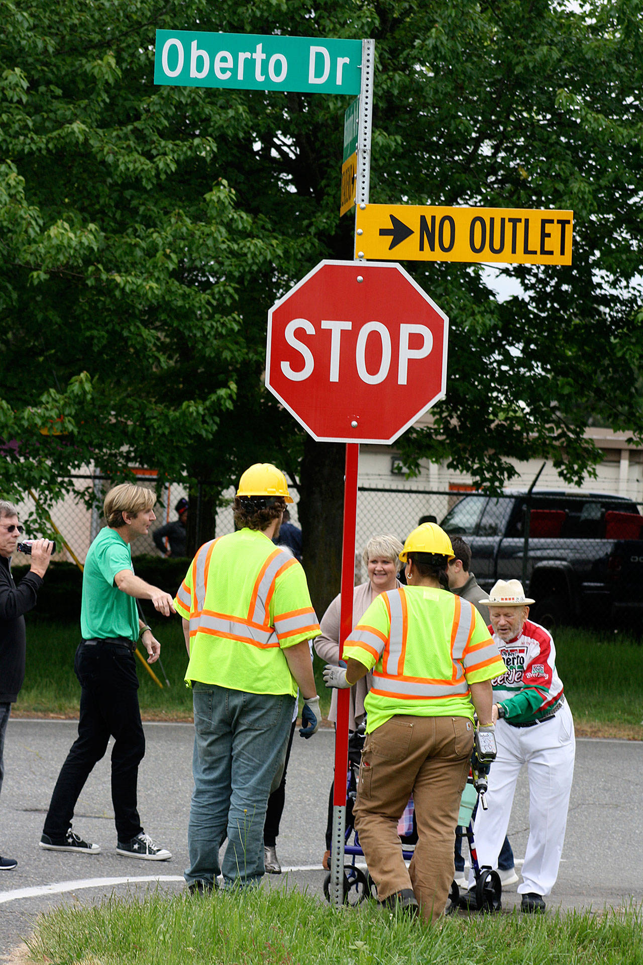 A city of Kent Public Works crew chats with Mayor Dana Ralph and Art Oberto after installing a new street sign Thursday renaming a short section of South 238th Street to Oberto Drive in honor of the jerky company’s 100th anniversary this year. The company’s headquarters and manufacturing facility sit at the end of the street. STEVE HUNTER, Kent Reporter