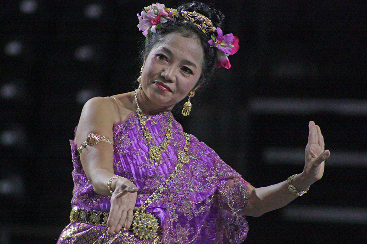 Pimana Thichalad, a leader of Siam Smile Dance, a Thai classical and folk performance group, entertains on the Arena Stage at the Kent International Festival last year. Thichalad, originally from Bangkok, Thailand, has been teaching Thai classical dance for more than 50 years. MARK KLAAS, Kent Reporter