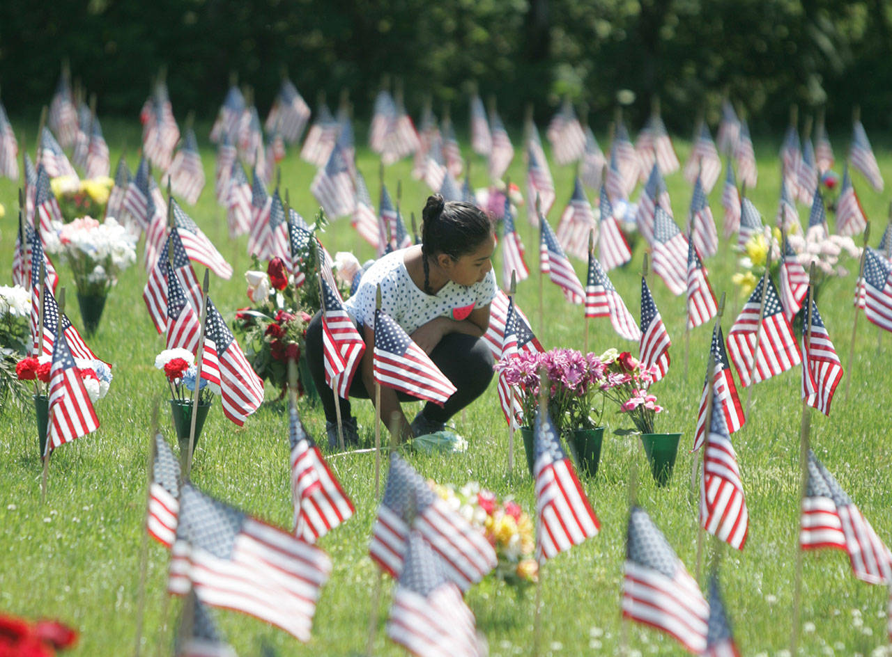 On Memorial Day, individuals and families pause to remember the fallen at Tahoma National Cemetery. REPORTER FILE PHOTO
