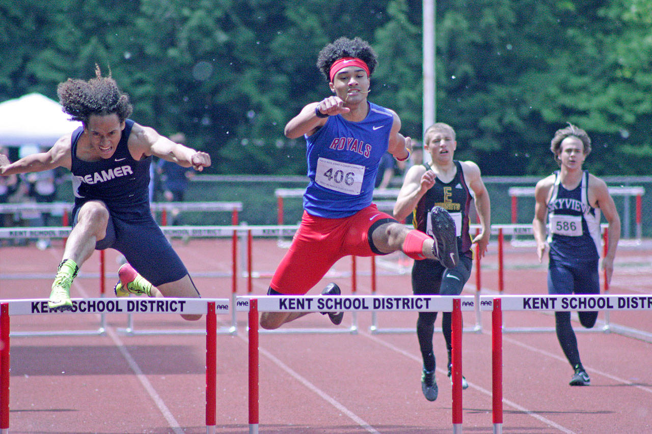 Todd Beamer’s Kobe Okezie, left, tries to catch Kent-Meridian’s Alex McGeachy in the 300-meter intermediate hurdles final at the 4A West Central District track and field championships at French Field last Saturday. Okezie edged McGeachy for the win. MARK KLAAS, Kent Reporter