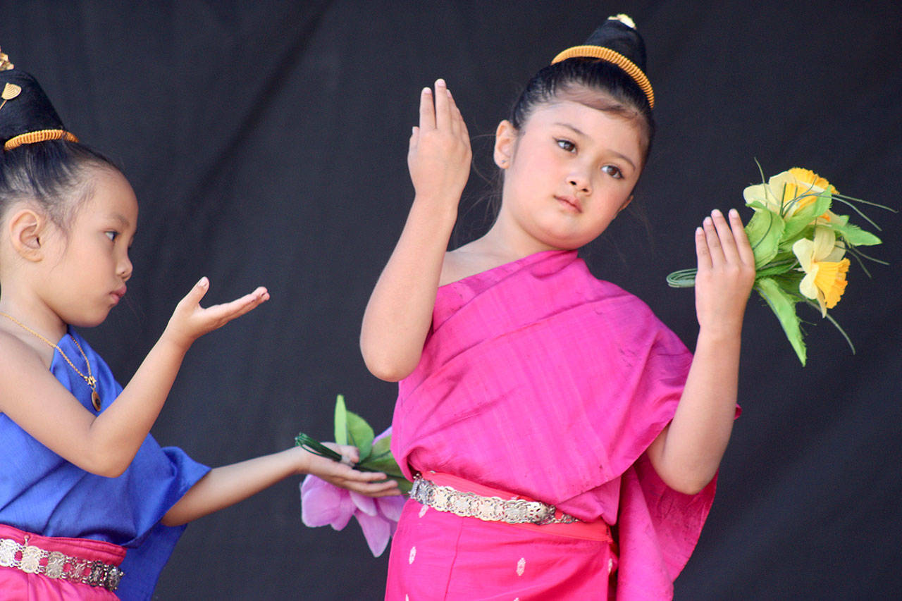 Young performers from the Kinnaly Lao Traditional Music Dance Troupe move to song on the Plaza Stage during the 10th annual Kent International Festival last Saturday. MARK KLAAS, Kent Reporter