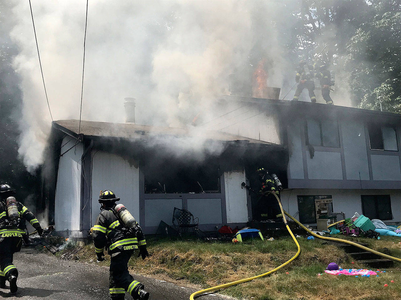 Firefighters work to control a Kent house fire Tuesday. COURTESY PHOTO, Puget Sound Fire