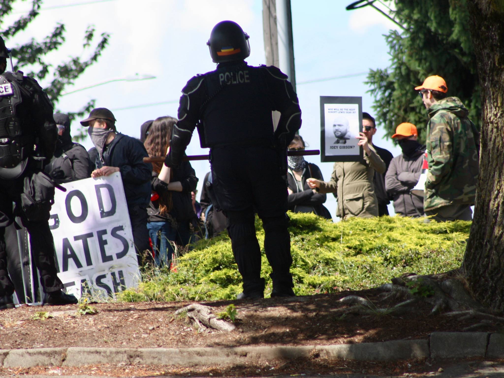Riot-prepared police keep watch on an anti-fascist group, keeping protesters from engaging the Patriot Prayer, pro-life gathering at a demonstration Saturday outside the Planned Parenthood – Kent Valley Health Center. MARK KLAAS, Kent Reporter