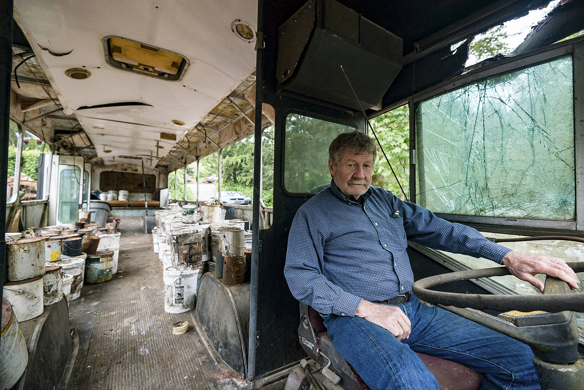 Charles Pillon sits inside one of the several buses on Iron Mountain. Photo by Caean Couto
