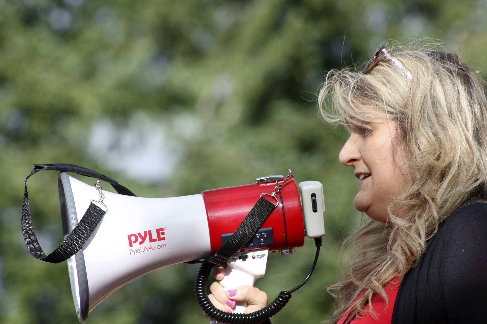 Christie Padilla, president of the Kent Education Association, leads a rally in front of the Kent School District Office on Wednesday. Padilla called on district leaders to support teachers with better pay. MARK KLAAS, Kent Reporter